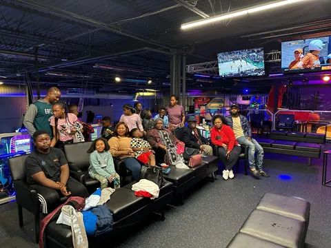 Family gathered together at an arcade lounge