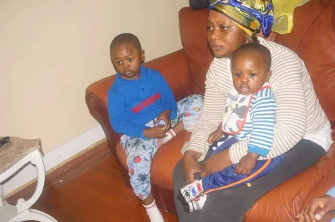 Memuna with her grandchildren on a couch