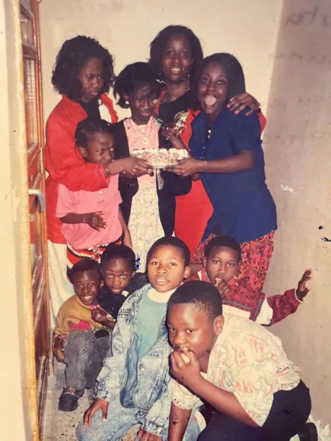 Memuna celebrating with friends and a birthday cake