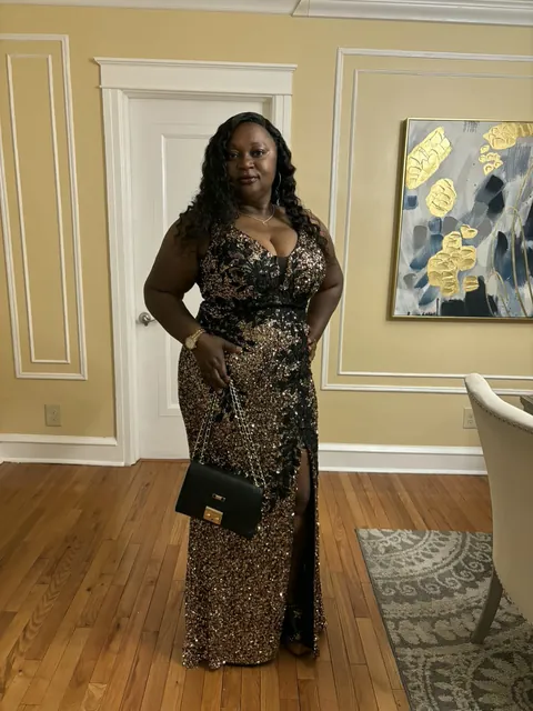 Memuna in an elegant black and gold sequined gown