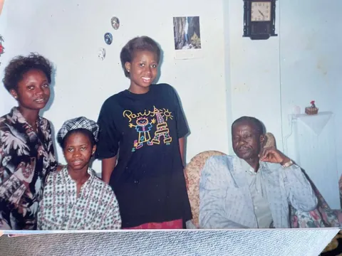 Family portrait at home with father seated