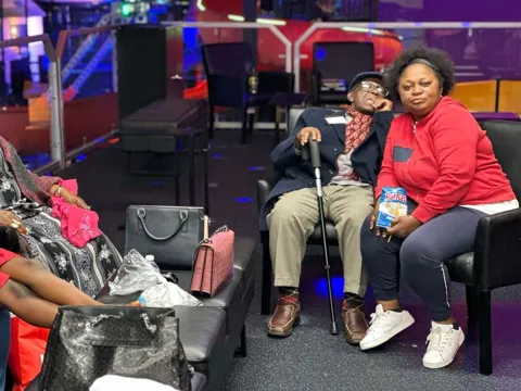 Elderly couple sitting together at the arcade lounge