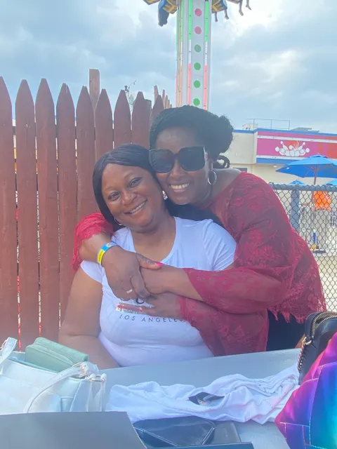 Memuna hugging a loved one at the boardwalk