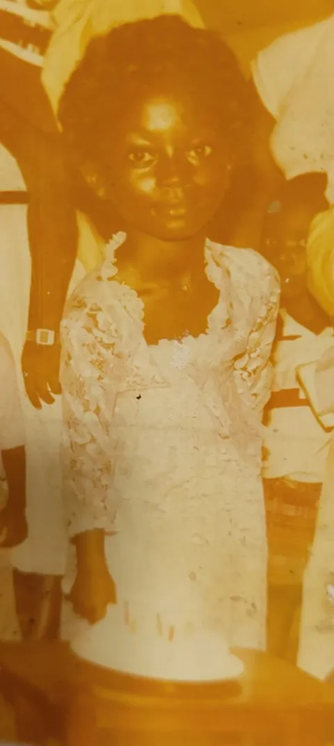 Vintage childhood portrait in a white lace dress