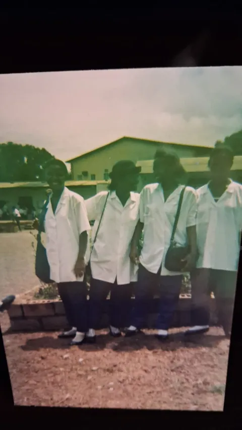 Memuna with school friends in uniform